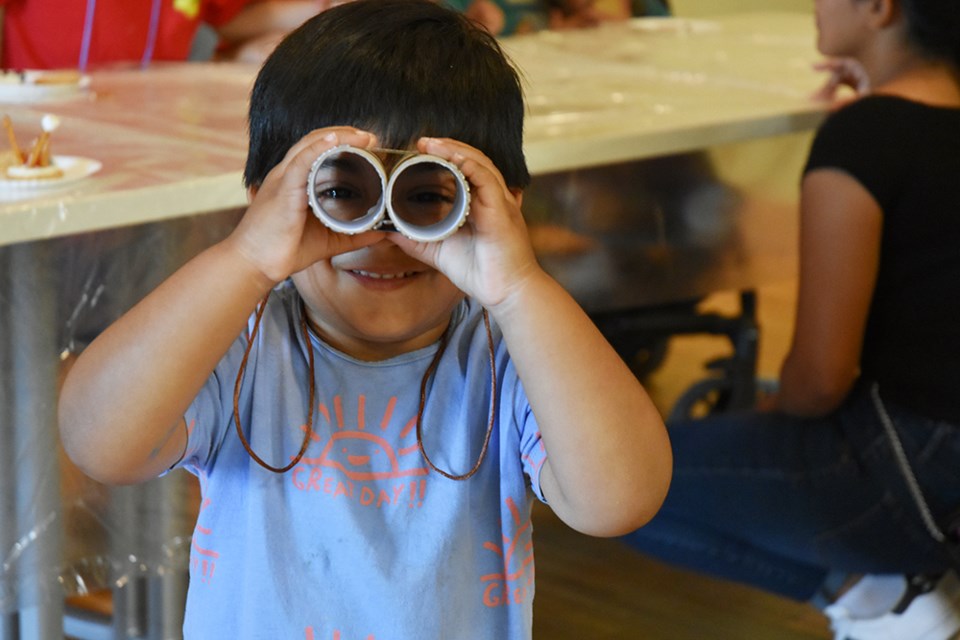 Ahad, three, made his own binoculars at the Bradford library’s Camp Party. Miriam King/BradfordToday