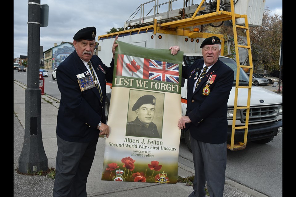 Bradford's Legion President Mike Giovanetti, left, and Veteran Services Officer George Neilson with a banner honouring Albert Felton, who served in the Second World War. Miriam King/BradfordToday