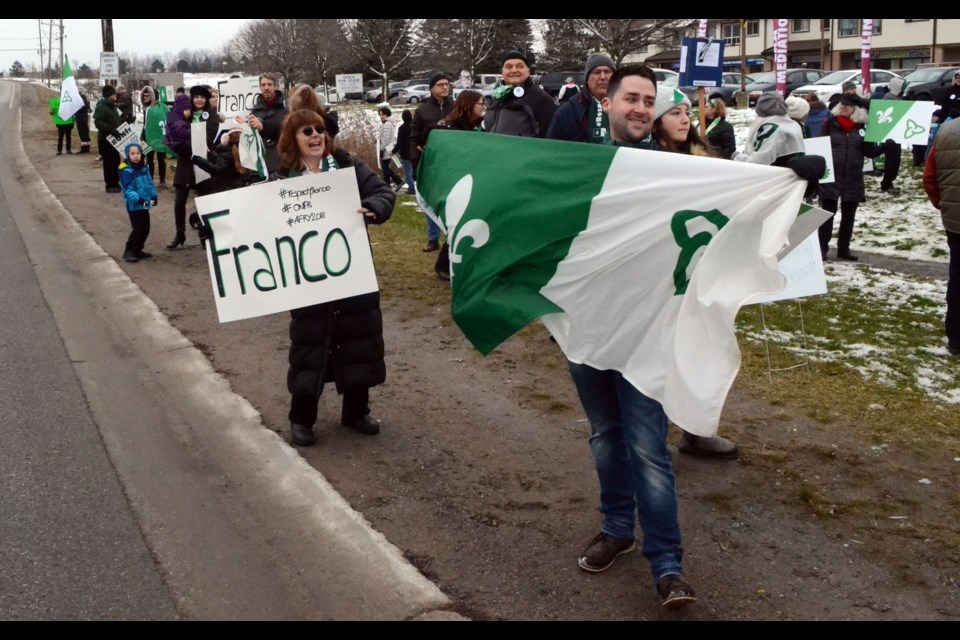  Flags, signs and lots of people could be seen from Mount Albert Road Saturday, as protesters gathered in front of the riding office for York-Simcoe MPP Caroline Mulroney. Patrick Bales for BradfordToday