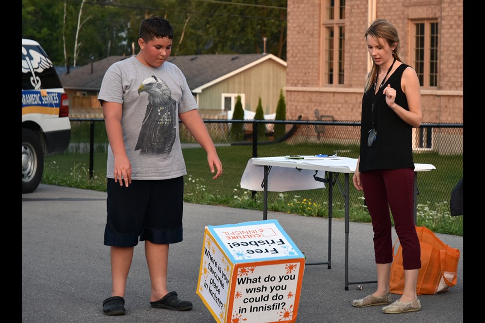 Rolling the giant dice at the Gilford Neighbourhood Night, participants could be asked their opinion on services, or could win a Frisbee. Miriam King/BradfordToday