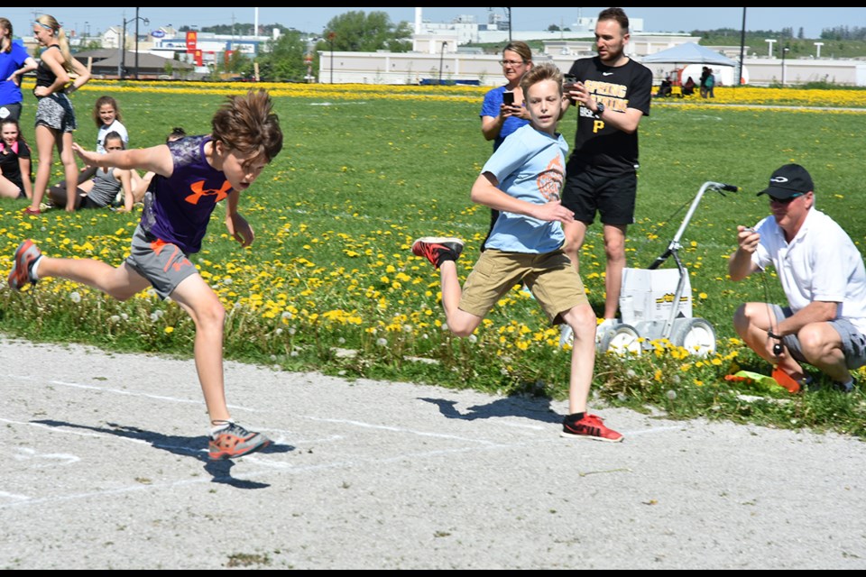 Running heats at the W.H Day Elementary School track and field day, held at Holy Trinity Catholic High School May 25. Miriam King/Bradford Today