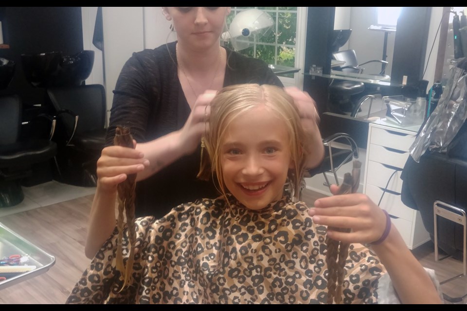 Adriana Verkaik with her new short haircut and the tresses she will donate to Pantene Beautiful Lengths, to make wigs for cancer patients. Submitted photo 
