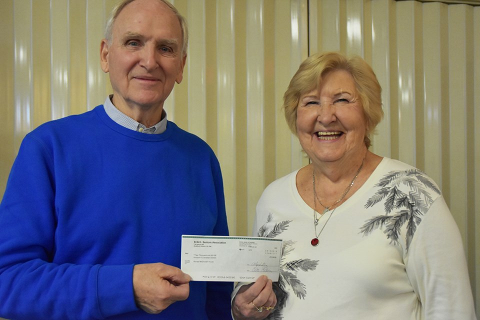 Danube's past president Elaine Love presents a cheque to Mike Irwin of Ronald McDonald House, representing the funds raised through Gwilly pin sales at this year’s Carrot Fest. Miriam King/BradfordToday