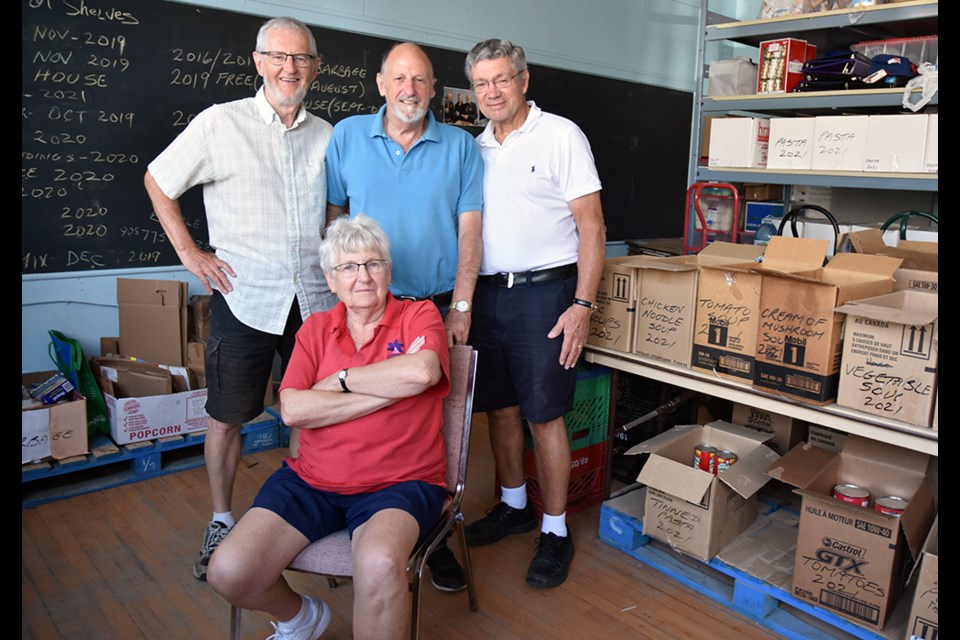Anne Silvey, seated, and from left, Oliver Pajunen, William Silvey and Terry Marshall at the Helping Hand Food Bank. Miriam King/Bradford Today