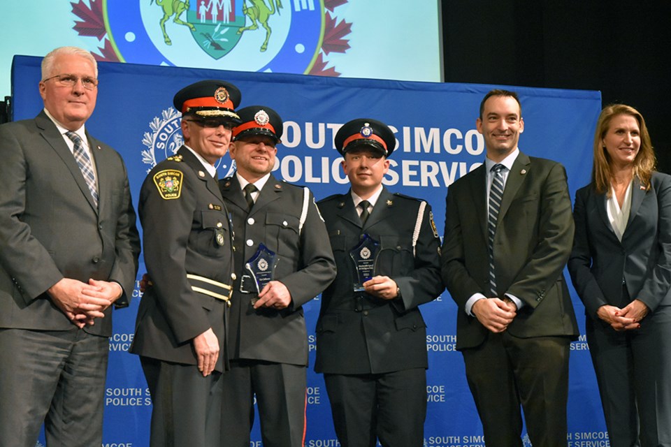 MP John Brassard (from left), South Simcoe Police Services Chief Andrew Fletcher, South Simcoe Police officer Kai Johnson, York Regional Police Det. Colin Organ with awards for Excellence in Investigation, police services board chair Licinio Miguelo, and York-Simcoe MPP Caroline Mulroney. Miriam King/Bradford Today