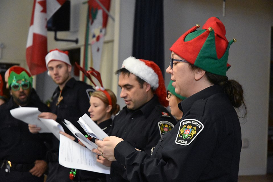 South Simcoe Police Special Const. Elisabeth Aschwanden, right, and friends lead the carolling at the Danube Seniors Leisure Centre. Miriam King/Bradford Today