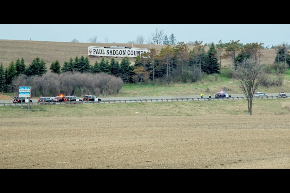 Police examine scene where death occurred on Highway 400 near Highway 88.