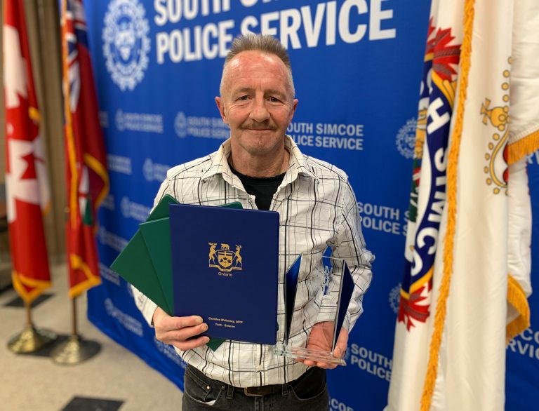 Allan MacPherson with his Citizen Award at the South Simcoe PoliceService Awards 2022