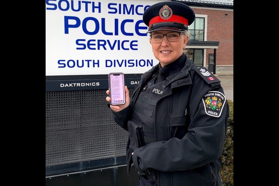 Acting Staff Sgt. Leah Thomas of the South Simcoe Police Service is shown with an example of a text message that will be sent to those who report incidents.