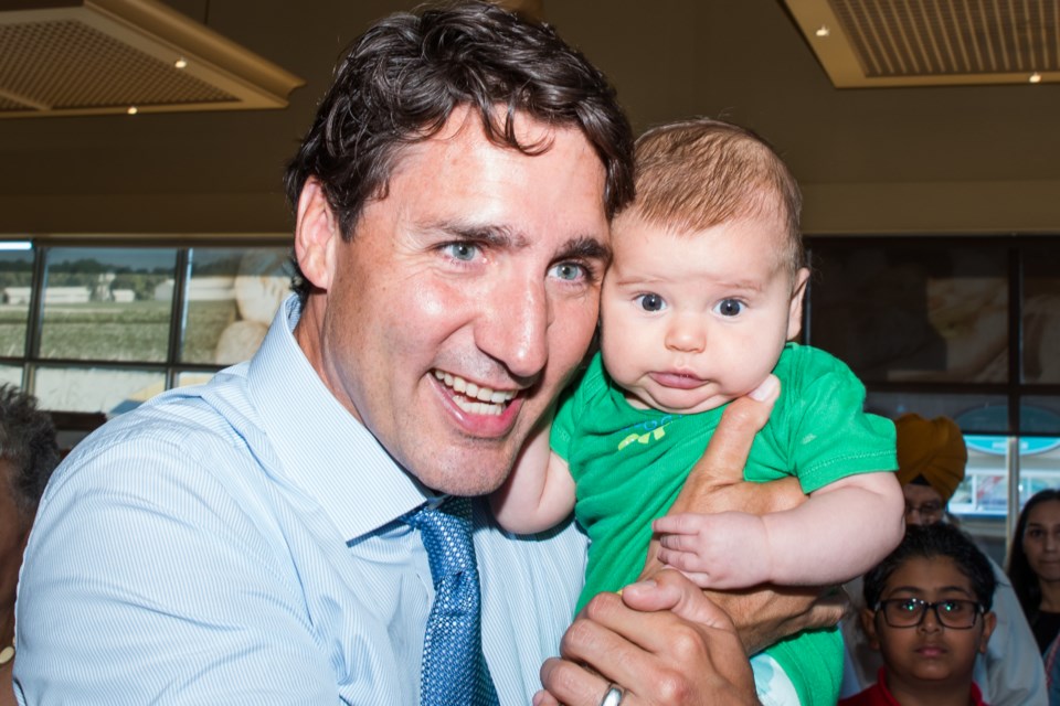 Prime Minister Justin Trudeau with a baby at Caldense Bakery in Bradford West Gwillimbury during a surprise visit. Paul Novosad photo 