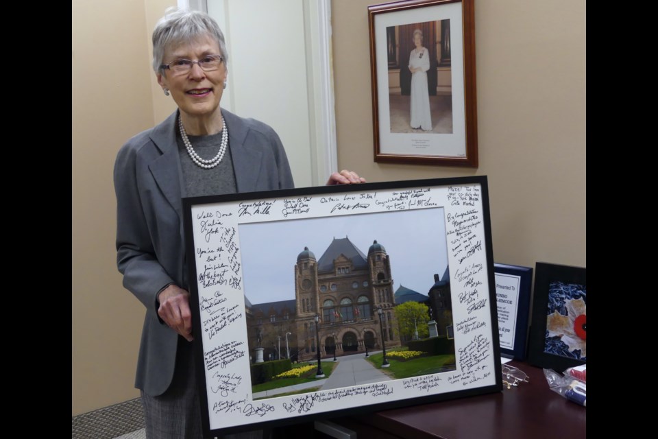 York-Simcoe MPP Julia Munro shows off a framed photo of the Ontario legislature, which is signed by all the other Ontario MPPs for her retirement. Jenni Dunning/Bradford Today