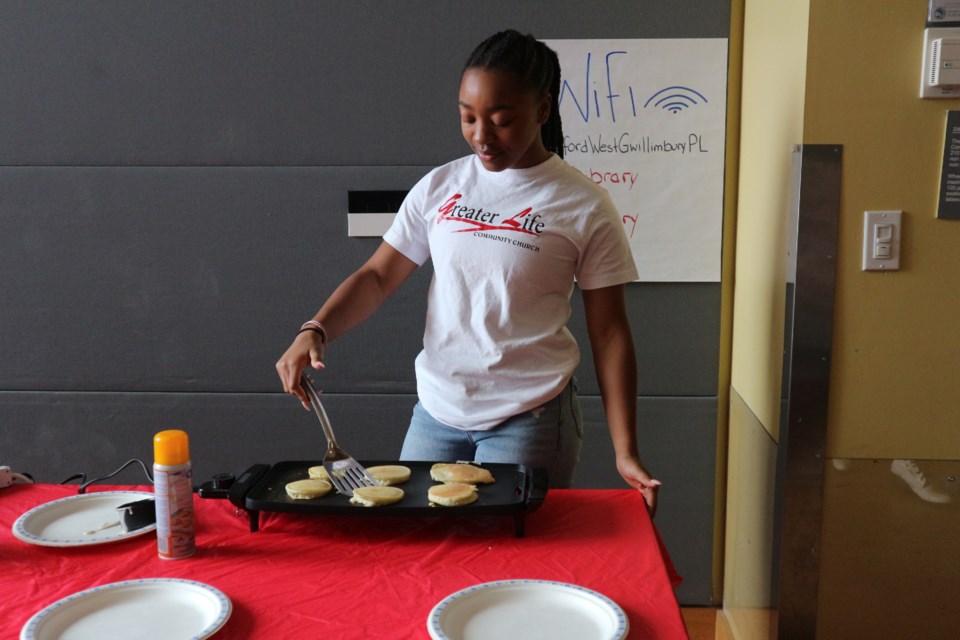 Akxenia Grant grilling up some fresh, fluffy pancakes. Natasha Philpott/BradfordToday                               