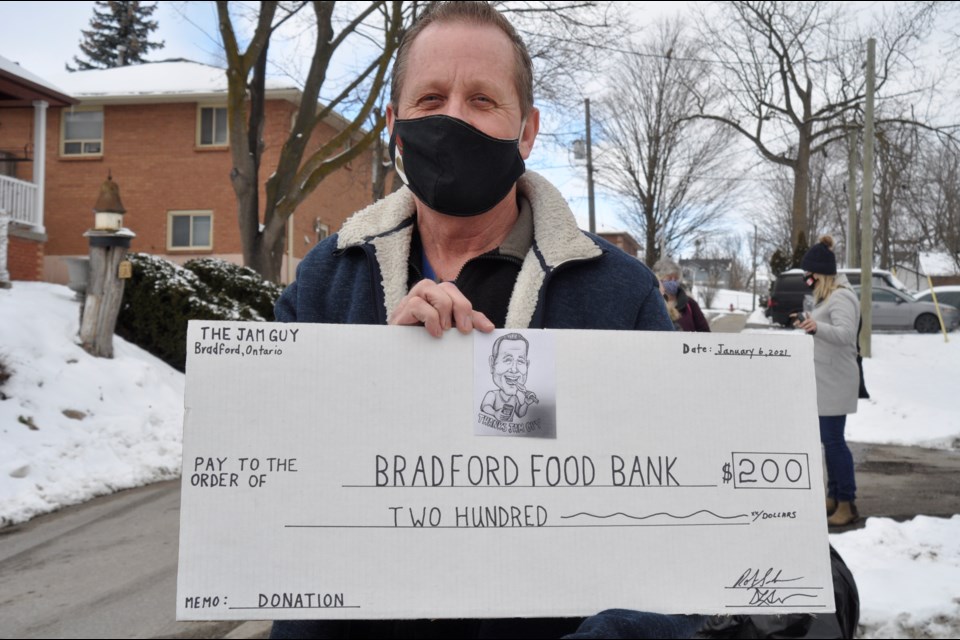 The Jam Guy (Robert Salmons) donated $200 to the Helping Hand Food Bank, and MP Scot Davidson matched his donation, totaling $400. 