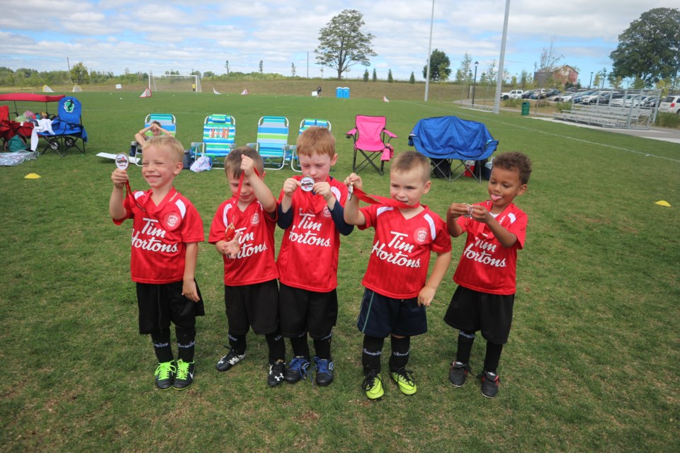 Timbits soccer players showing off their shiny medals. Natasha Philpott/BradfordToday                               