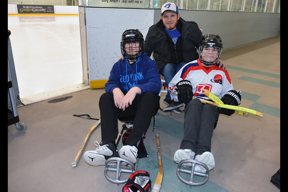 Coach and paralympian Brad Bowden with two of his sledge hockey players at the BWG Leisure Centre's green rink. Miriam King/Bradford Today