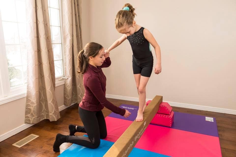 Alexa Doucet works with a gymnastics student one-on-one. Submitted photo 