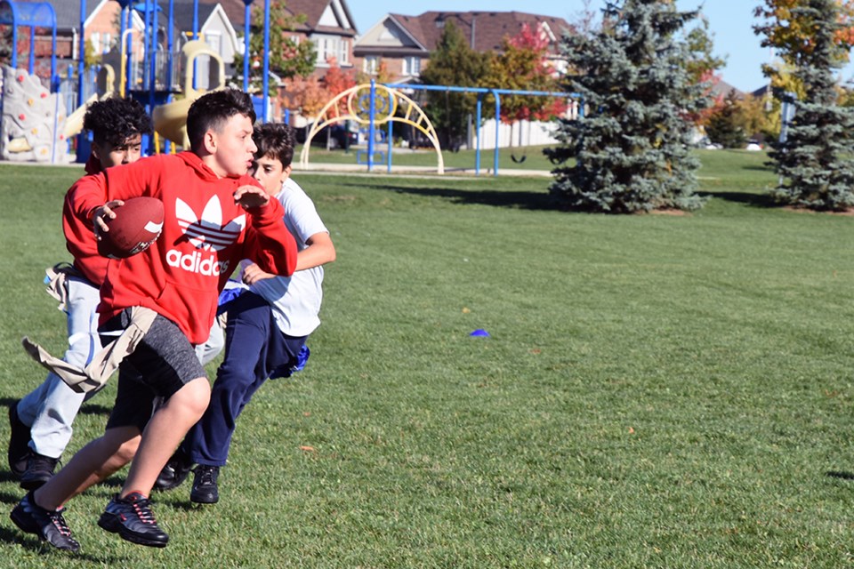 Running with the ball, in the Turkey Bowl. Miriam King/Bradford Today