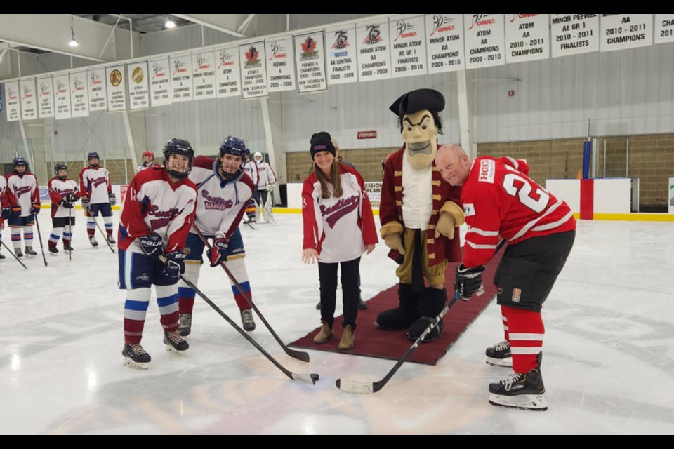 Nottawasaga OPP detachment commander Insp. Steve Ridout participated in the ceremonial puck drop during a charity hockey game Wednesday against the Banting Memorial High School Marauders.