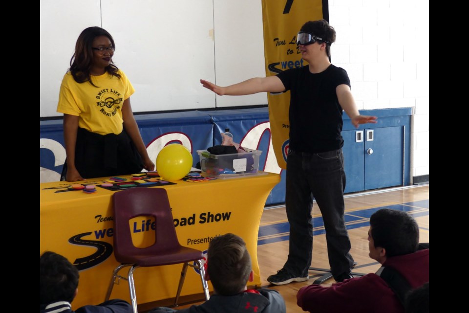 Garrick Paquette tries out a pair of alcohol impairment simulation goggles at Sweet Life Roadshow at Bradford District High School April 26. Jenni Dunning/Bradford Today