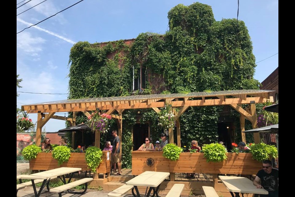 Griffin Gastropub, seen here in warmer weather, occupies a historic building of vine-shrouded brick, with a recently built patio covered in twinkle lights. Submitted photo 