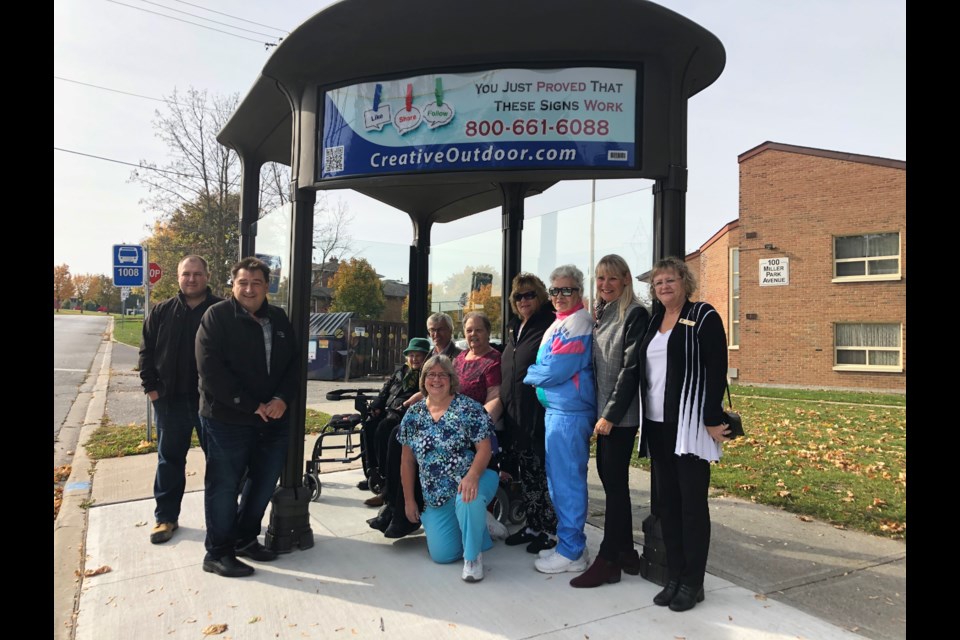 Mayor Rob Keffer, Coun. Peter Dykie, BWG Transit Technologist Paul Dubniak and CEO of CHATS Christina Bisanz with residents of 100 Miller Park Ave. on Monday morning celebrating the new bus shelter. Natasha Philpott/BradfordToday