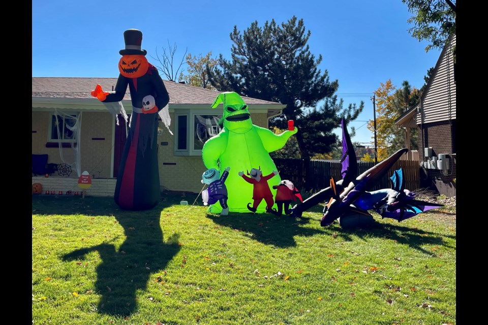 Massive, spooky characters loom in a yard on W Sixth Avenue in October 2022.