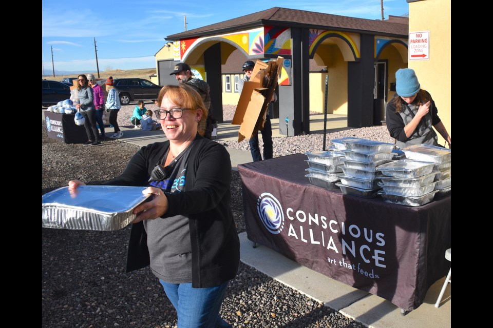 Volunteers distributed turkeys and side dishes to Marshall fire victims at Conscious Alliance in Broomfield on Tuesday.
