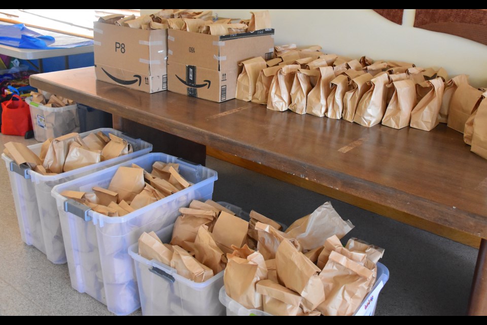 Piles of food packages for distribution by Broomfield FISH were assembled at Holy Comforter Episcopal Church on Saturday during Serve Weekend.
