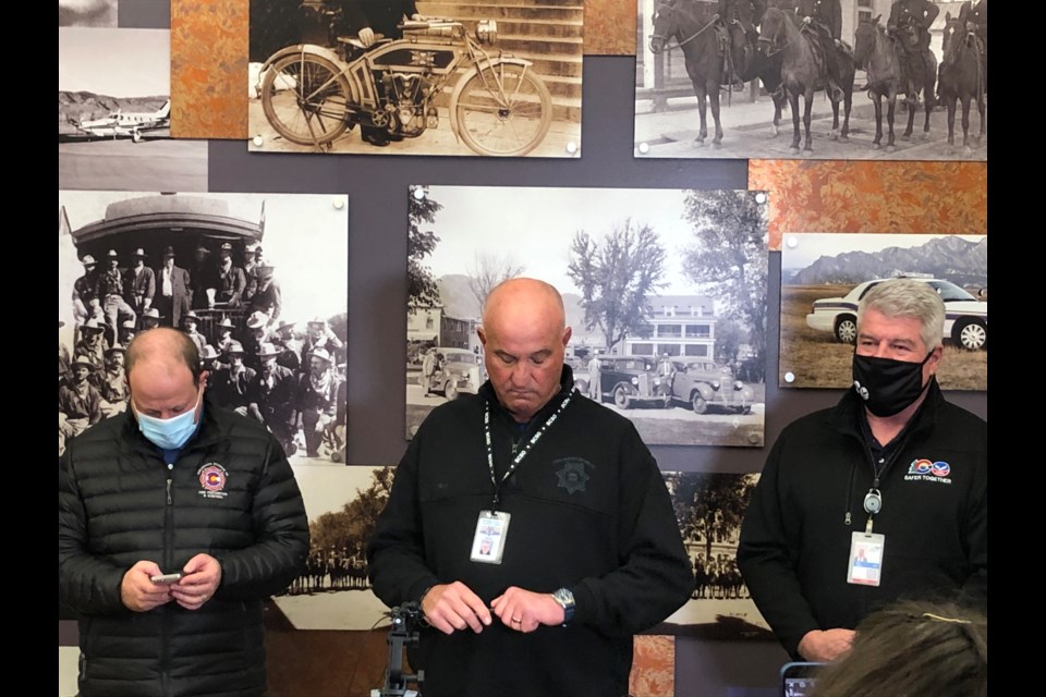 Gov. Jared Polis (left) Boulder County Sheriff Joe Pelle (center) and Colorado Public Safety Director Stan Hilkey (right) prepare for a press conference regarding the Marshall fire on Dec. 30, 2021.