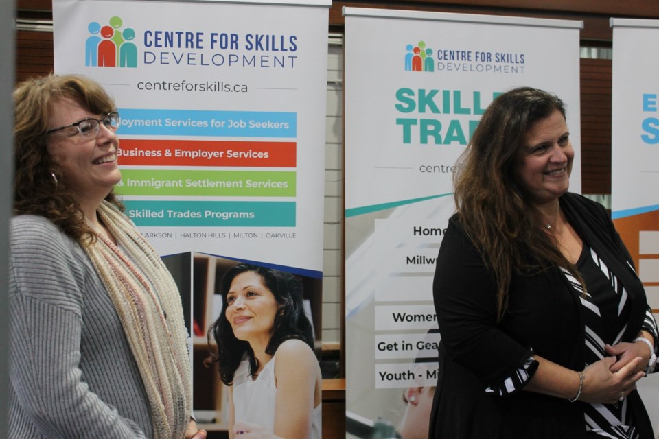 Jennifer Vanderbeek (left) and Lisa Rizzato answer questions from visitors at the Centre for Skills Development booth at the Burlington Chamber of Commerce MEGA Business After 5 Oct. 19.