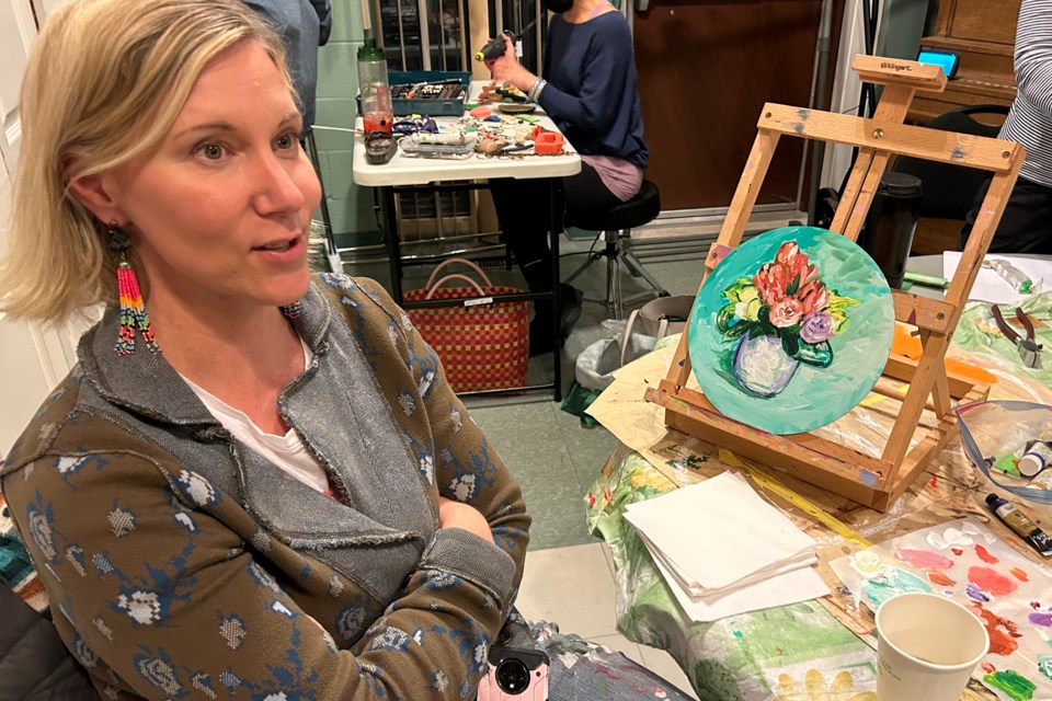 Artist Heather de Haan takes a break from working on an acrylic painting during the March session hosted by Elizabeth Gardens Creative Collective.