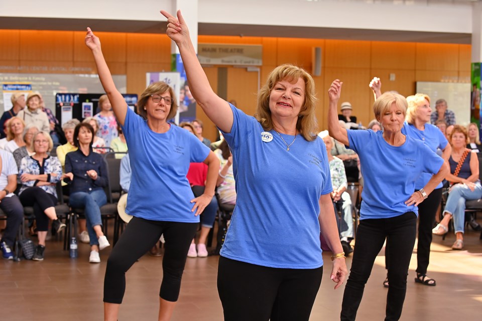 Mozelle Cole (centre) with Soumaya Baker (left) and Jan Emeneau perform in the Mattson & Company Line Dancing demo.