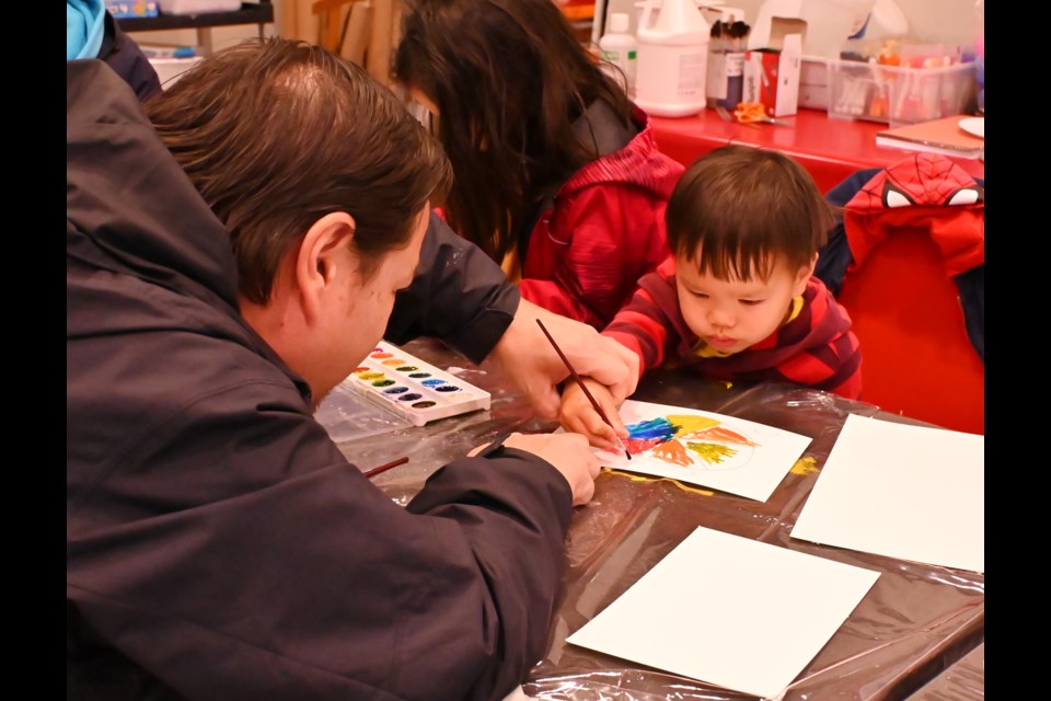 Rob Lau helps son Andrew during Family Open Studio at Burlington Art Gallery.