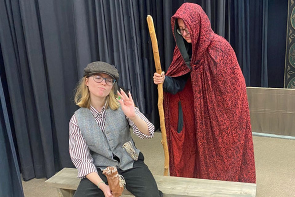 Jack (Michelle Krisfalusi Faric) examines the “magic beans” from the Old Lady (Ash McDonald) during a recent Theatre Burlington rehearsal.