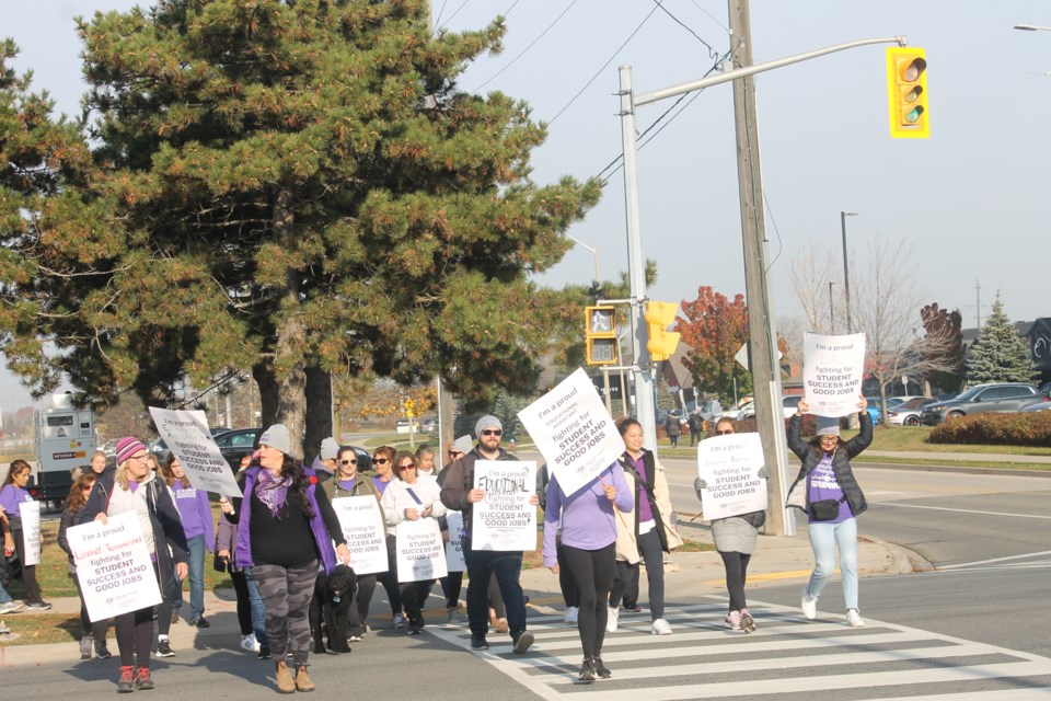 Hundreds of education workers protest at Guelph Line and Harvester Road on Friday morning. 