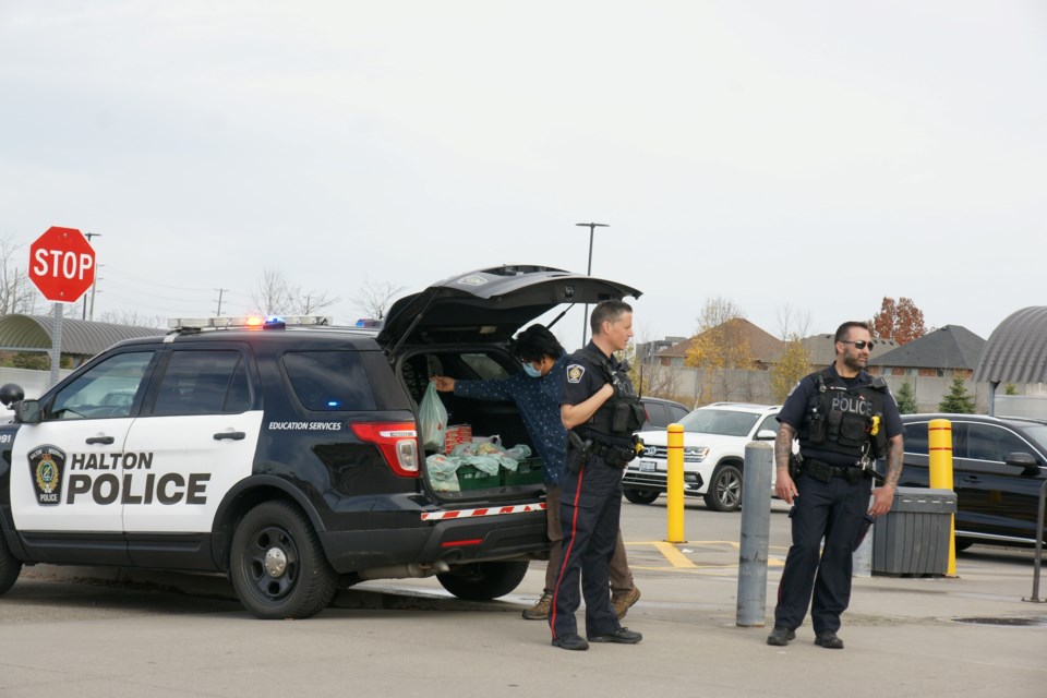 Shoppers at Fortinos on Appleby Line help fill a police car with donations Nov.5.