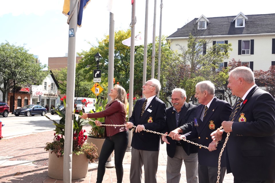 Raising the flag for Legion Week are (from left): Burlington Mayor Marianne Meed Ward, City Liaison/Museum Curator Bob Ankrett, Ward 6 Councillor Angelo Bentivegna, past president Burns Macleod and president Murray Sutherland.