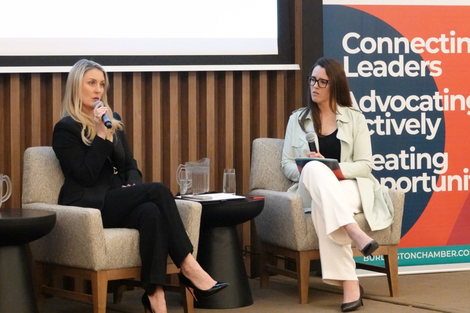 Business advisor and founder Ashley Deland (left) and Brittany Phillips, lead marketing advisor, Dion Strategic Consulting Group chat during a question and answer session.