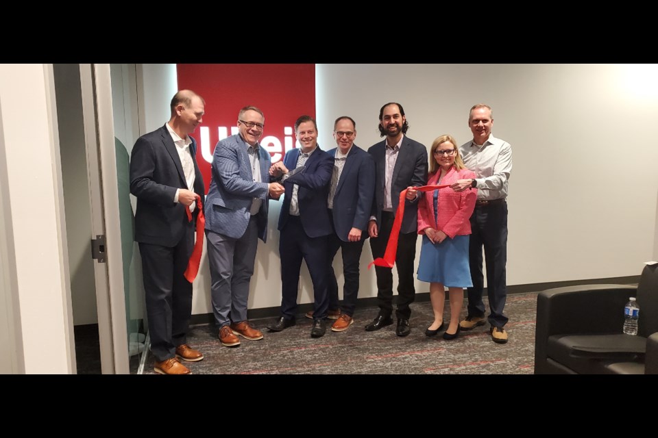 (Left to right) Michael Farrell, Doug Jaeger, Rory Nisan, Craig Davies, Hossein Tabrizi, Alison Barie and Jim Horn pose before officially opening the Burlington Ulteig office.