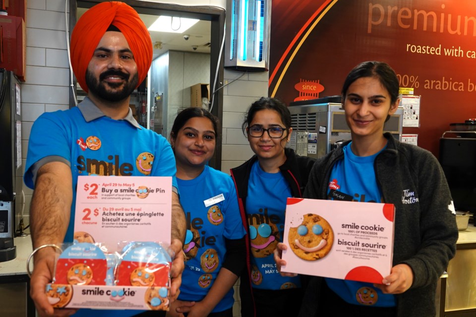 Even if you can't enjoy sweets, you can still enjoy a smile cookie button/pin. Staff show their support on Monday (from left): Gurjot, Navjot, Prab and Gagan.
