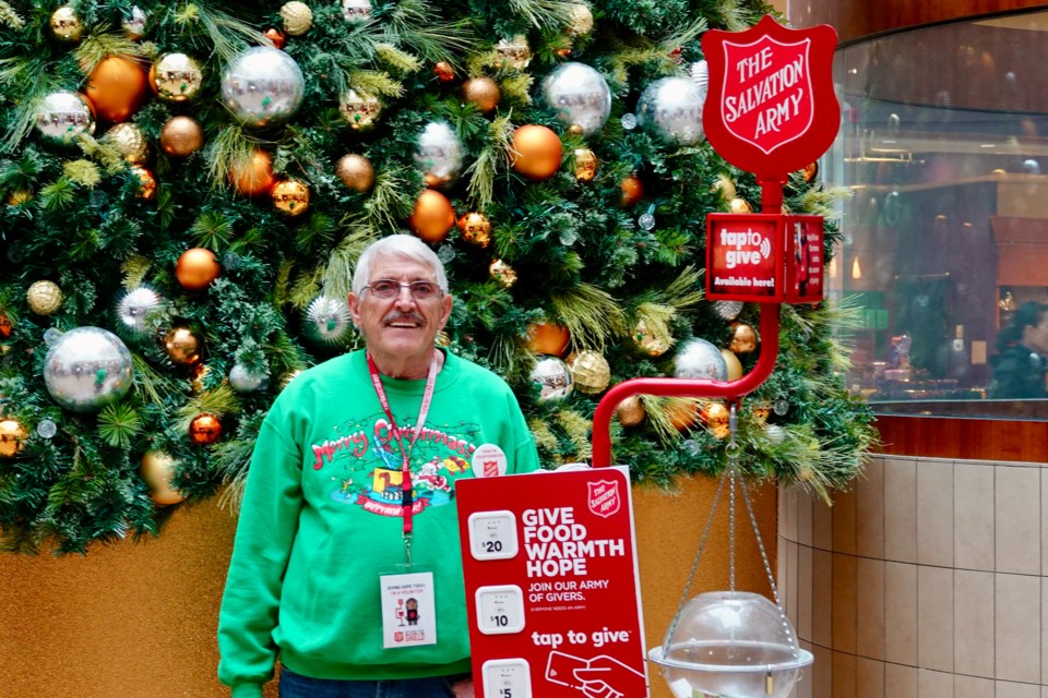 Burlington’s Salvation Army long-time volunteer Klaas Slagter stands with the familiar bubble at
Mapleview Centre during the Kettle Campaign kickoff Nov. 17.