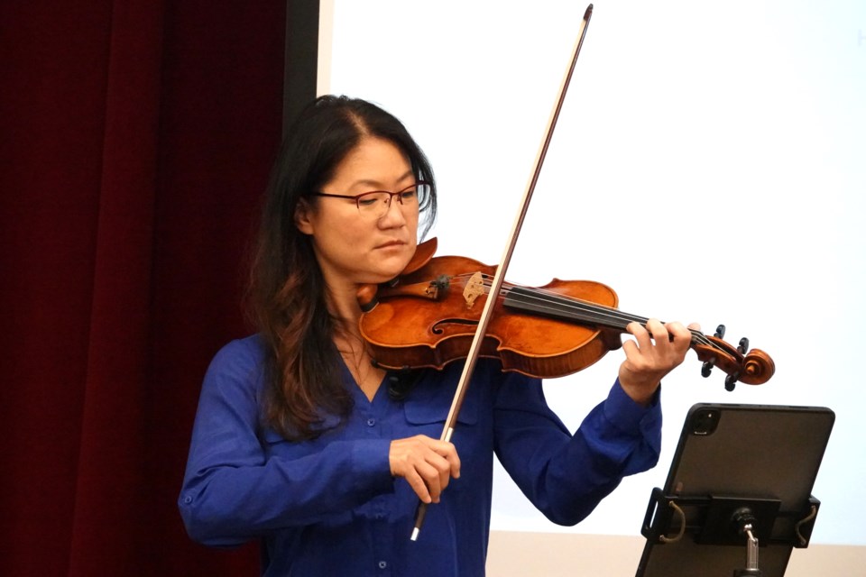 Hamilton Philharmonic Orchestra, which has a music for wellbeing program, provided a duo string performance. Here, Cecilia Chang on the violin.