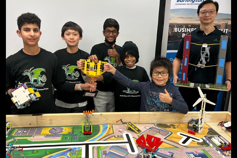 The GreenR Bots team (left to right) Abdurrahman Abdelhamid, Ted He, Sanjay Kolli, Sebastian Golec, Rex Li and mentor Frank He show off their fist-place trophy from the FIRST Lego League Ontario West provincials.