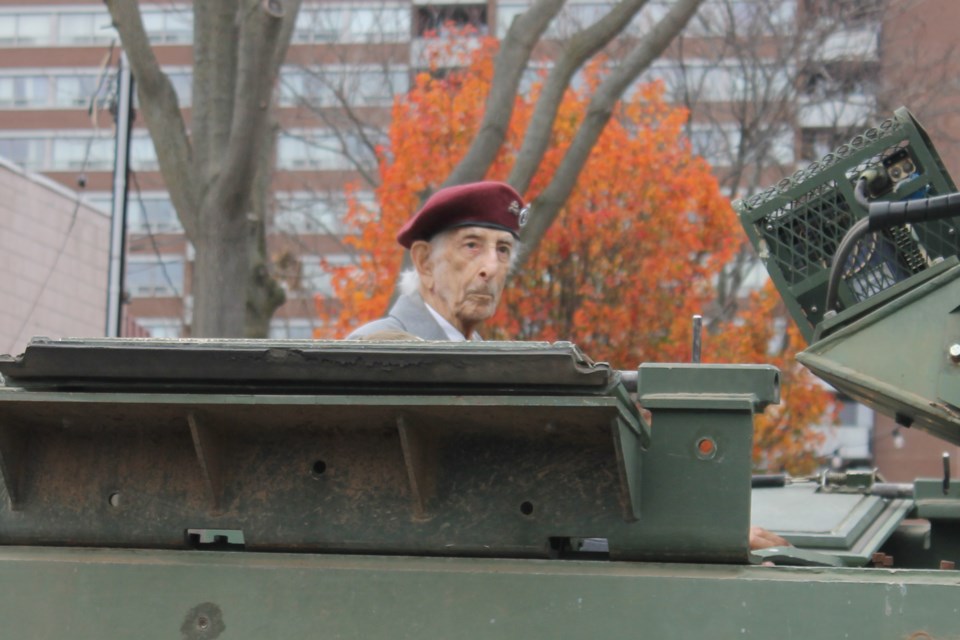 Second World War Veteran Gordon Schottlander, 97, travels the parade route in an M1-13 armoured personnel carrier. 
