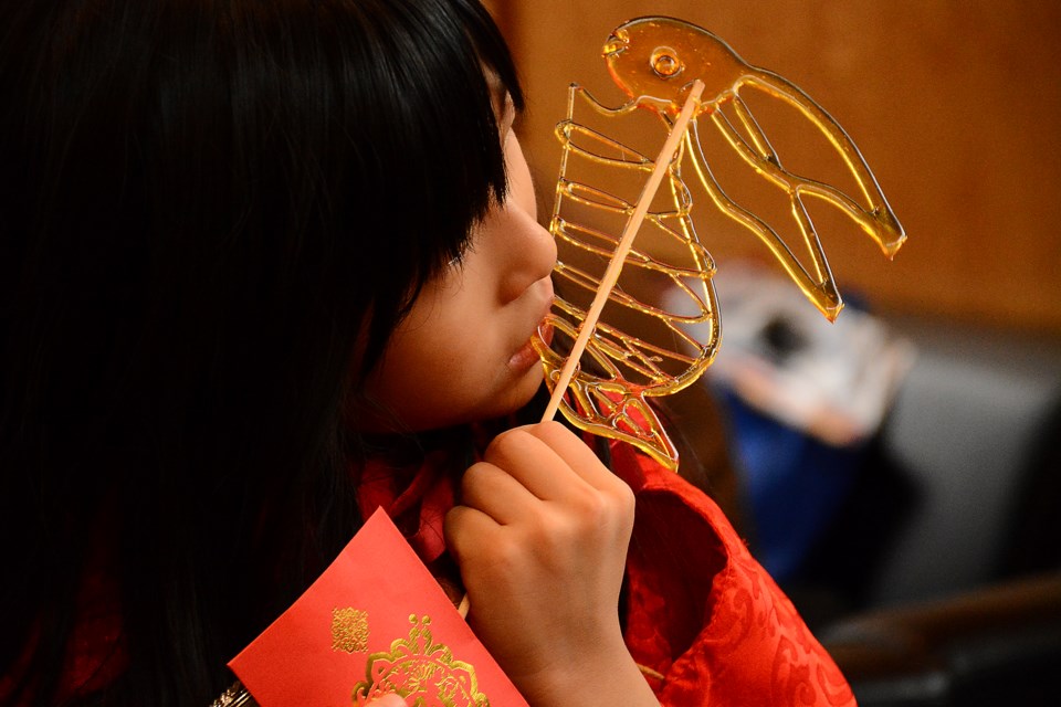 Grace Gao eats a sugar rabbit during the Lunar New Year festivities.