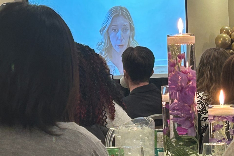 Guests at the Halton Women's Place lunch listen as Amy Kaufman appears via Zoom.