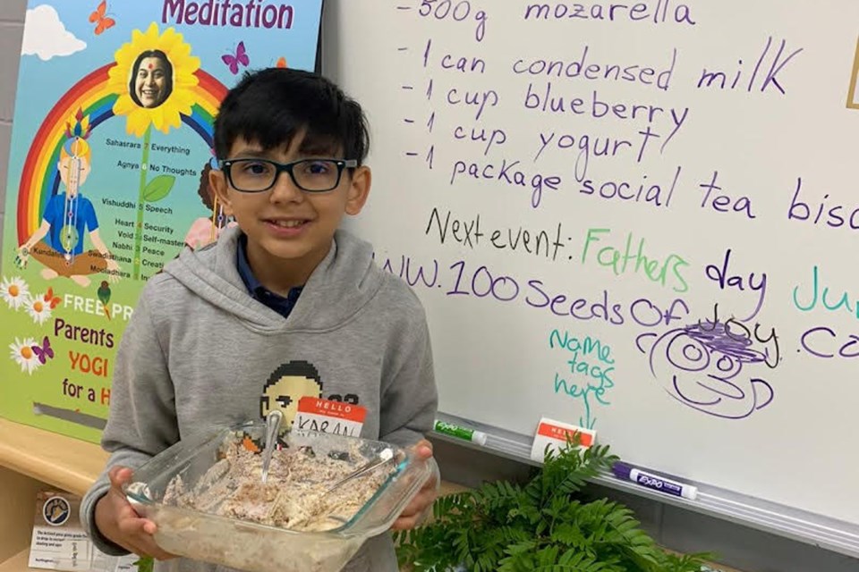 Karan Gandhi (12) proudly shows off  the cheesecake he made at the Cooking with Love event hosted by Sahaja Yoga Meditation June 3 at The Orchard Hub.