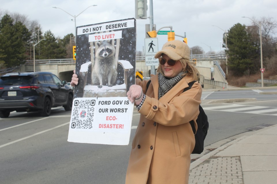 Leah Salt holds a sign during the Raccoon Freedom Fighters rally in Burlington March 20.