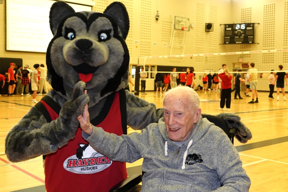 Dr. Frank J. Hayden Secondary School celebrated 10 years of educating on Friday. Here, Dr. Frank J. Hayden high-fives Frankie, the school's Husky mascot.