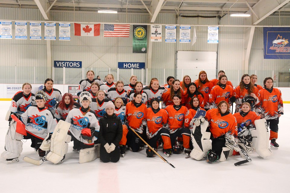 Burlington Blast and Finland Blue Ring Rockets players pose for a team photo during the exhibition game at the Appleby Ice Centre Feb. 20.